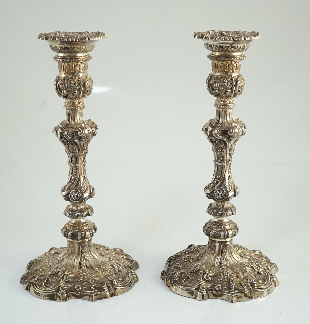 An ornate pair of Edwardian silver candlesticks, by Walker & Hall